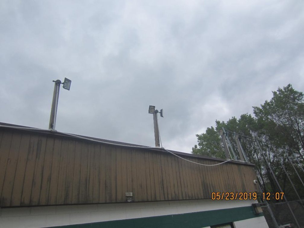 (3) Outside Lights Shining Over Volleyball Court