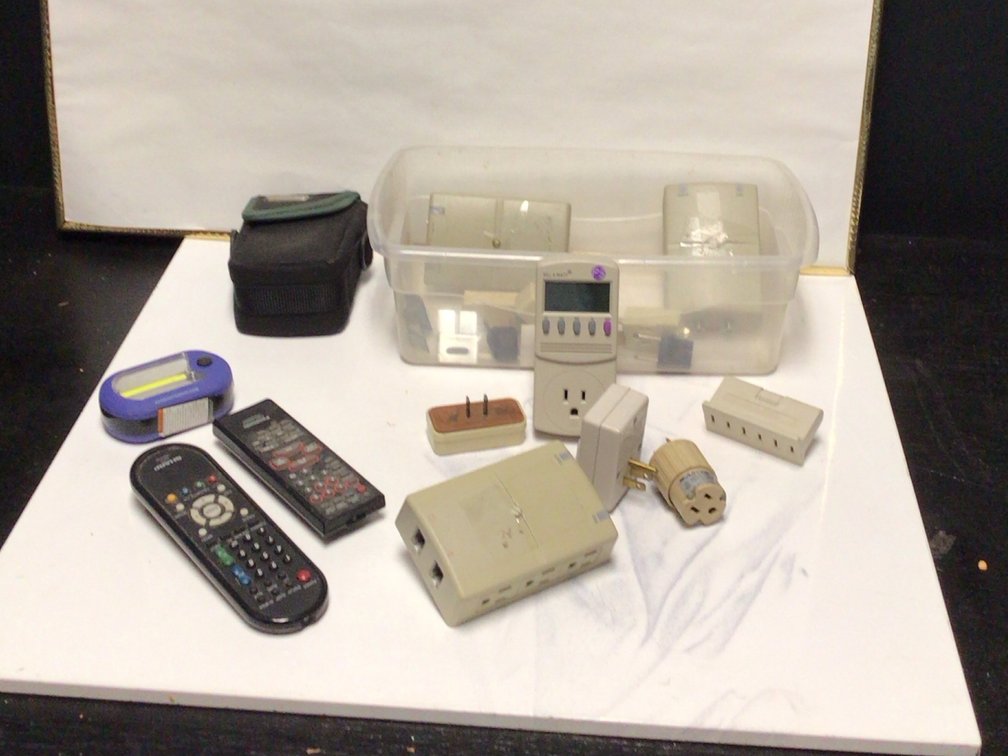 Assortment Off Remotes And Plug In Adaptors