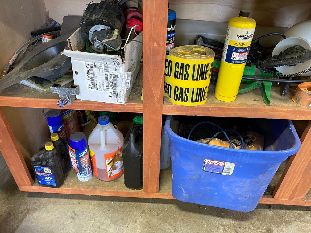 Contents under the bench:  Misc. items, sprayer, old motor, some wire