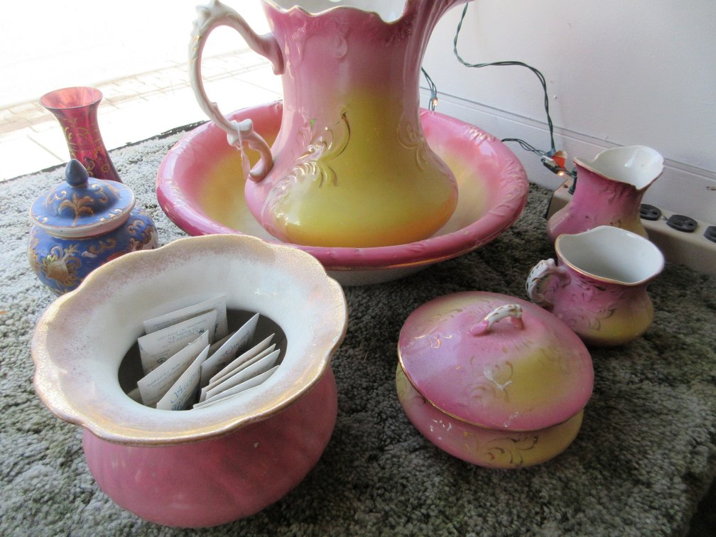 Bath set including pitcher, bowl, shaving mug, chamber pot, covered soap dish, and toothbrush holder with some misc. items