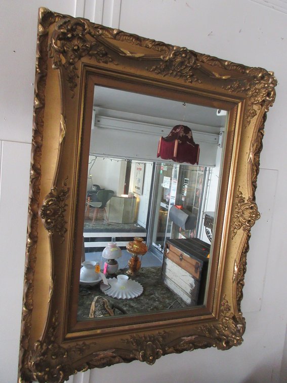 Wicker baby carriage, antique sign, some tapestry and wall mirror