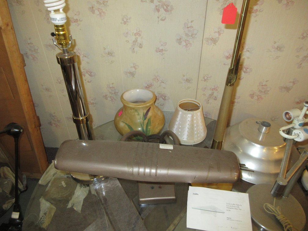 Glass top coffee table w/ clear base, some pottery, desk and floor lamps