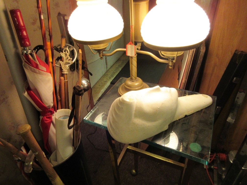 Umbrella stand w/ assortment of canes and umbrellas, little end table w/ wheels and table lamp