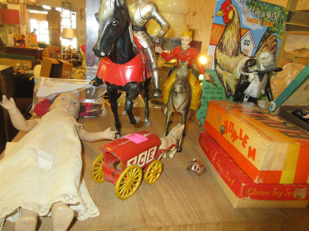 Assortment of toys:  Mother Hen game, some figurines, tin wagon that says California Trails, Tinker Toys, some metal cars, an old doll