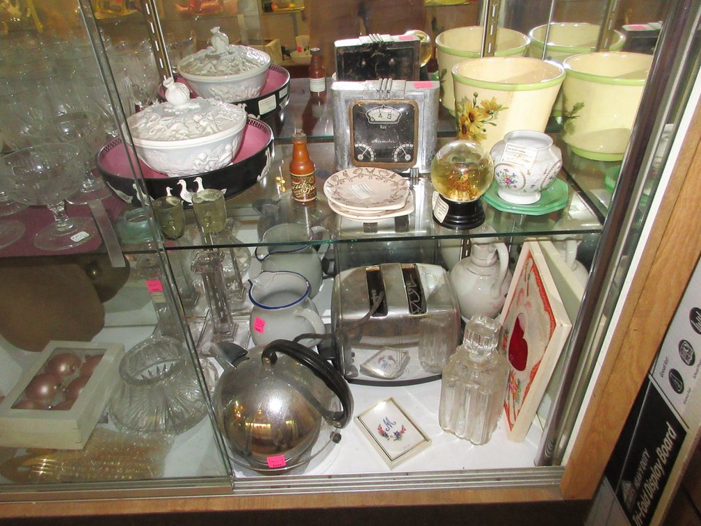 Contents in the display case:  Glassware, old teapot, toaster, pitcher, Air Meter clock, some misc. items