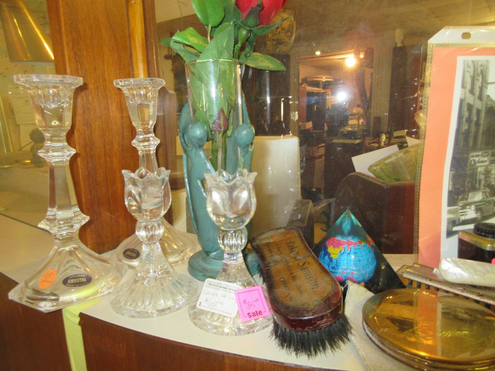 Contents on top of the counter:  Crystal candlesticks, old brush from Baker Samson, various candlesticks, large covered candy dish and aluminum light