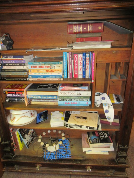 Contents of bookshelf:  3-4 Shelves of books; shelf is NOT included