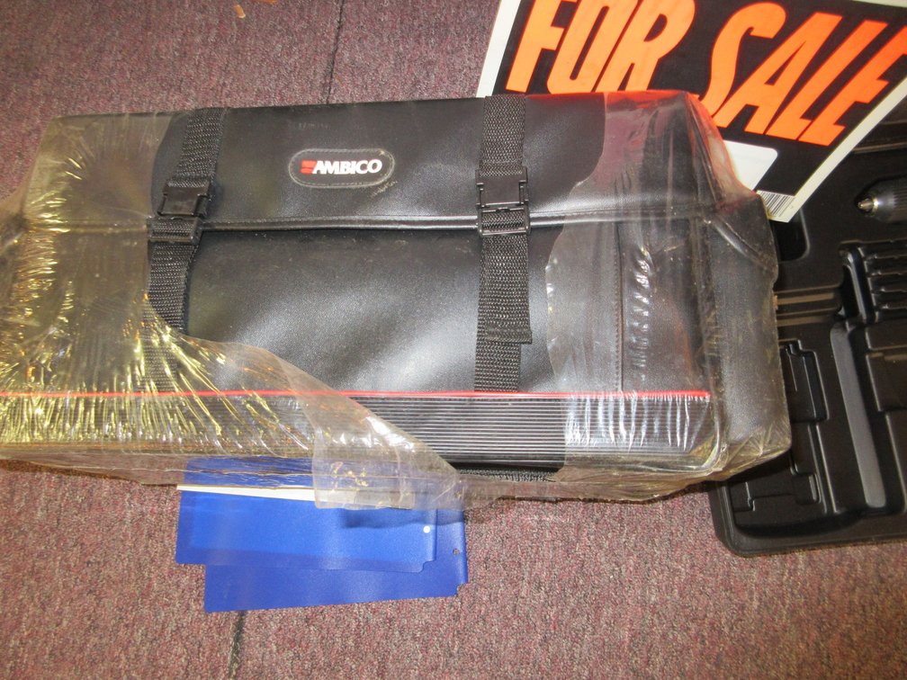 Wagner cordless drill (no charger or other accessories), small metal trash can and travel bag