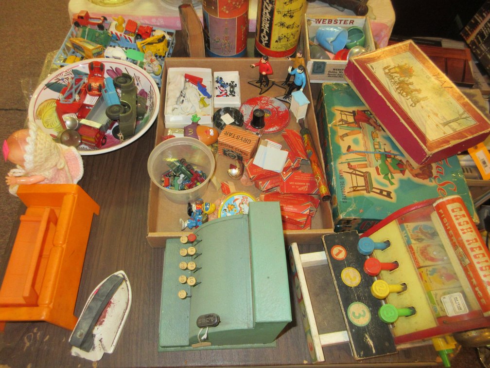 Table top full of kid's toys:  Cash registers, small figurines, small toys, plastic toys, Tinker Toys, misc. kid's toys