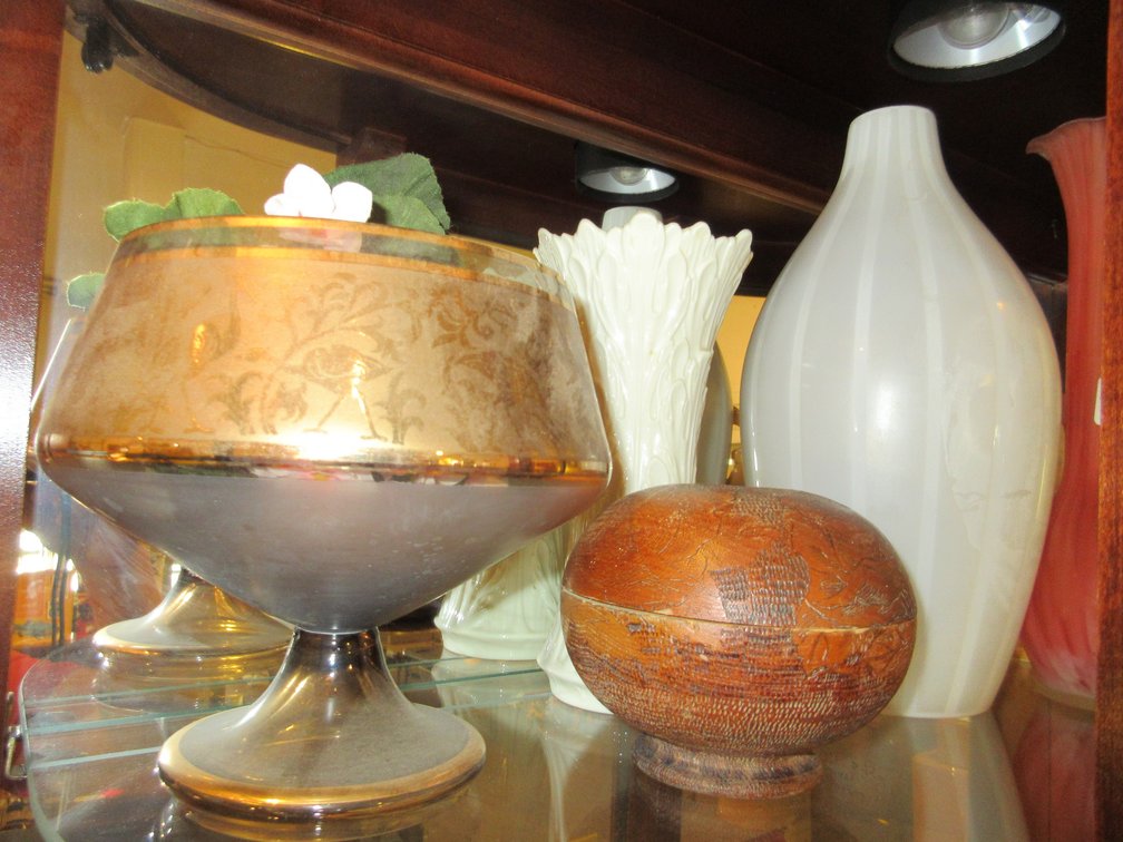 Top shelf in display case:  Assorted vases, Limoges piece, misc. glass