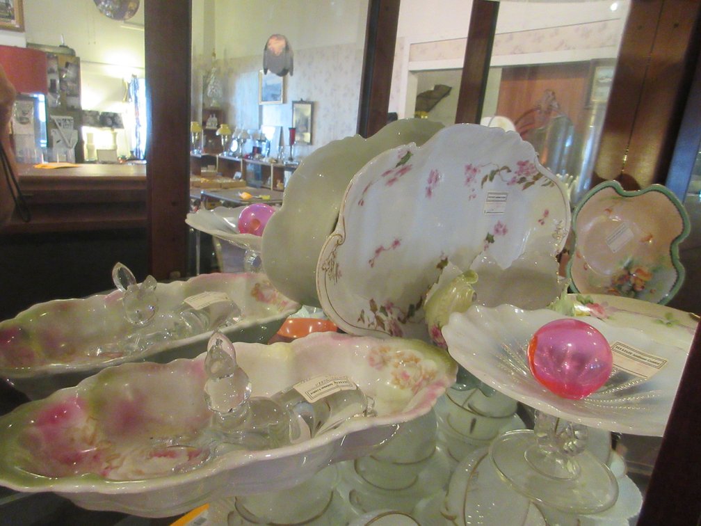 Second shelf:  Haviland platter, some Nippon, other assorted glass and some rabbit figurines