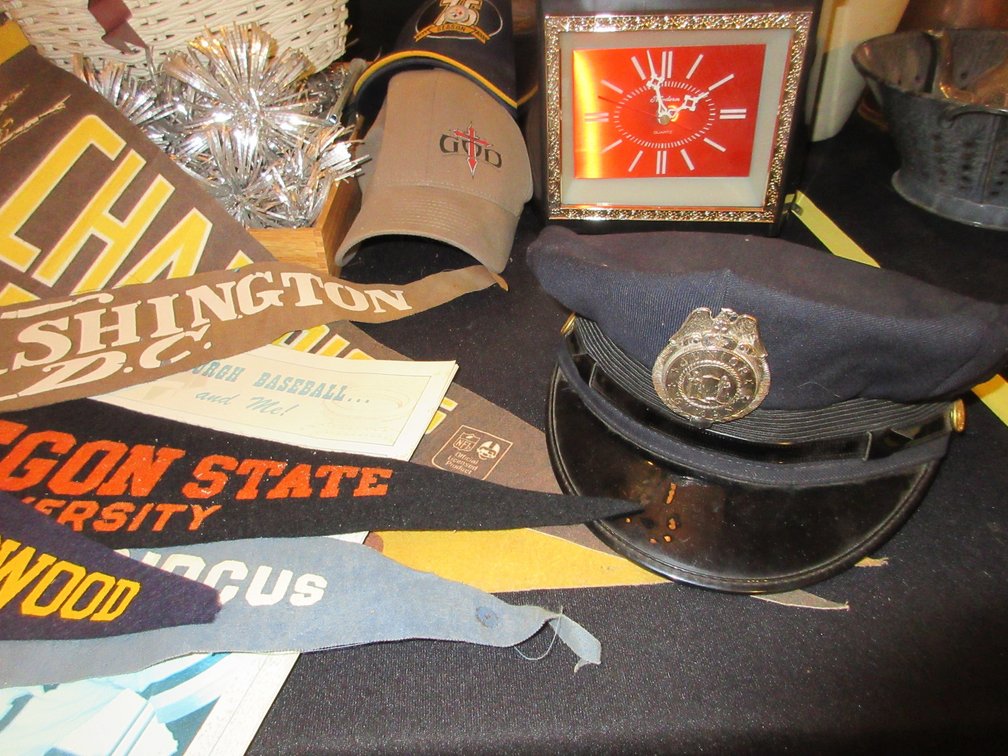 Some pendants:  Steelers, Washington DC, Oregon State, some ball caps, officer's hat, basket w/ misc. items and a clock