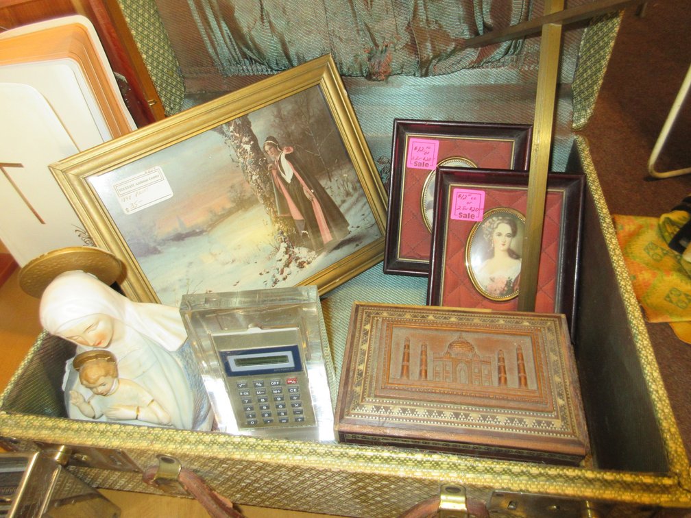 Some books on collectible aluminum, aluminum cake cover, small suitcase w/ prints and inspirational items, old toaster