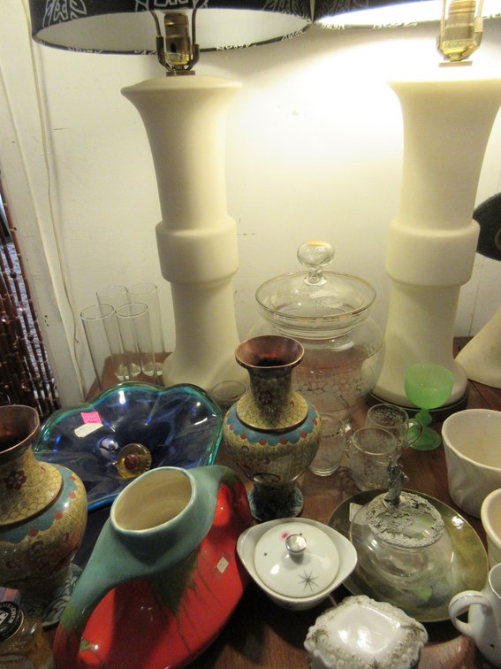 Contents on top of the drop-leaf table:  2 Table lamps, some vases, some small cups, metal vases and little dresser box