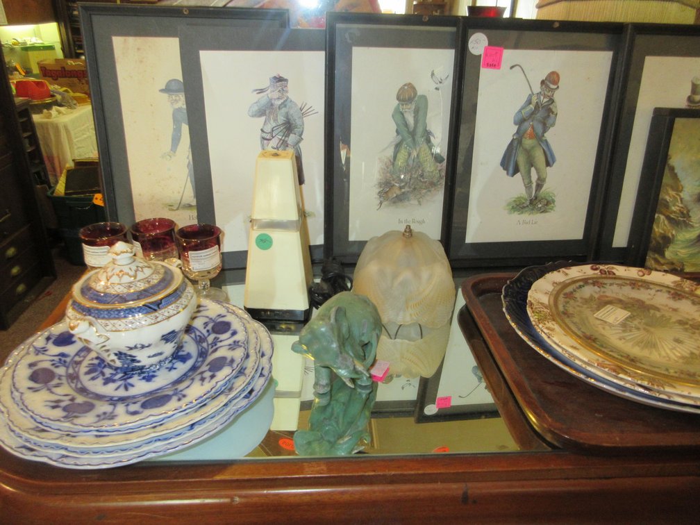 Contents on the stand:  Dishes, some small glasses, cranberry King Crown 2-oz. wine glasses, some golfing prints, large old coffee dispenser; stand is NOT included