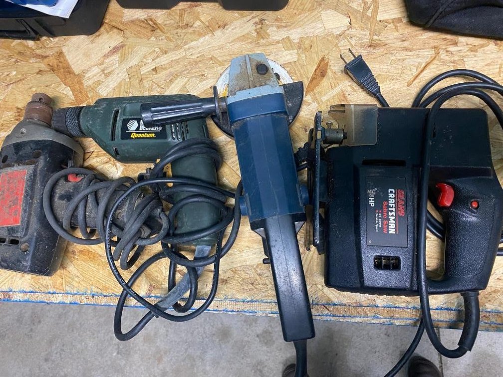 Assortment of drills, Black & Decker, angle grinder and Craftsman Sabre saw