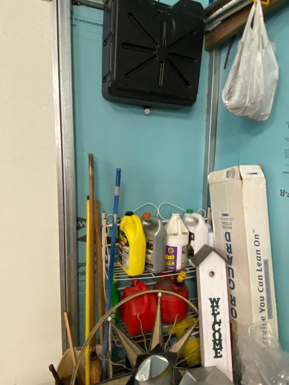 Contents of wall:  Oil-catch pan, gas cans, anti-freeze, other items