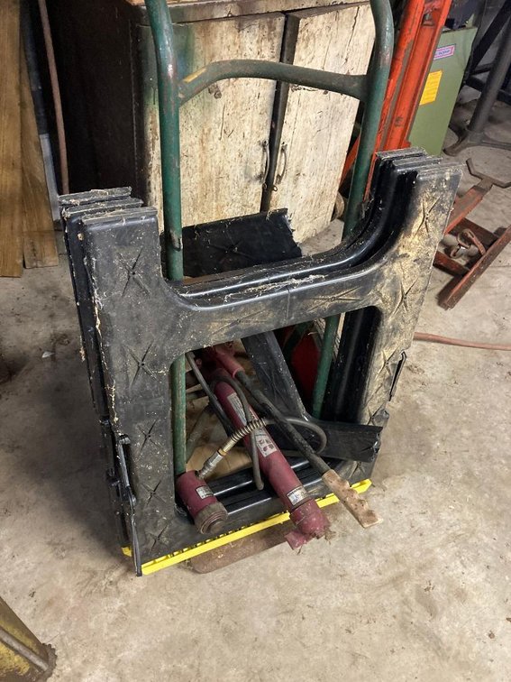 Porta Power, hand truck and 2 plastic sawhorses