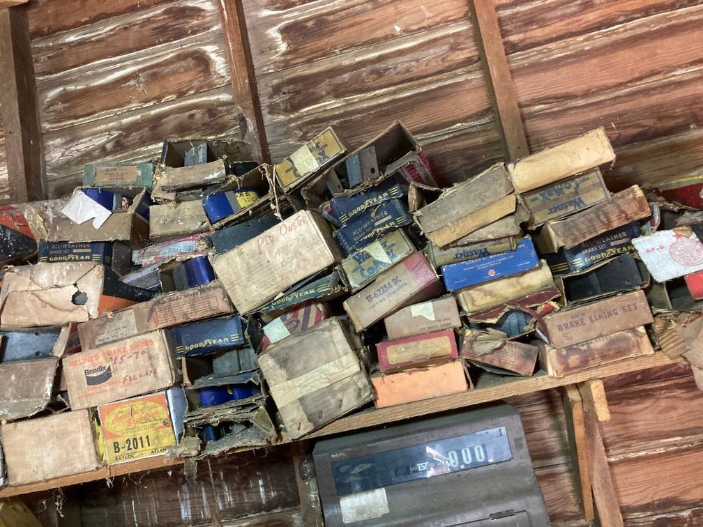 Lot of brake shoes in boxes on shelf as found