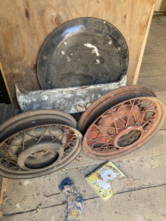 Lot of vintage auto parts:  Wire wheels, fender skirts as shown