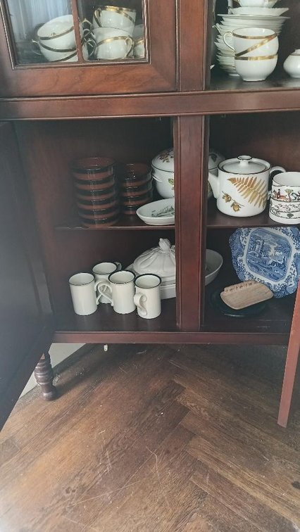 Assorted dishes in cabinet lower shelves