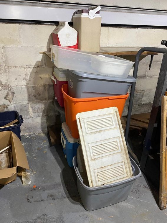 Lot of plastic storage containers and coolers