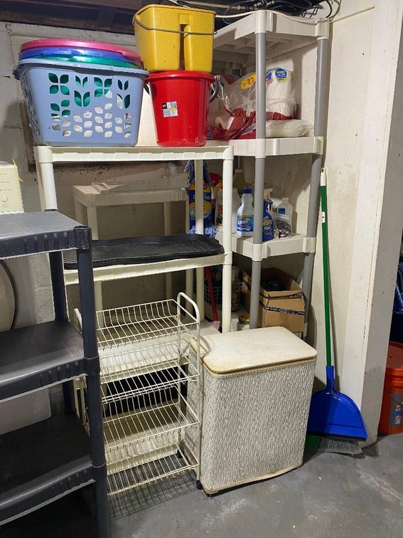 Plastic shelves, baskets in the laundry room w/ contents:  Hamper, metal bin, etc.