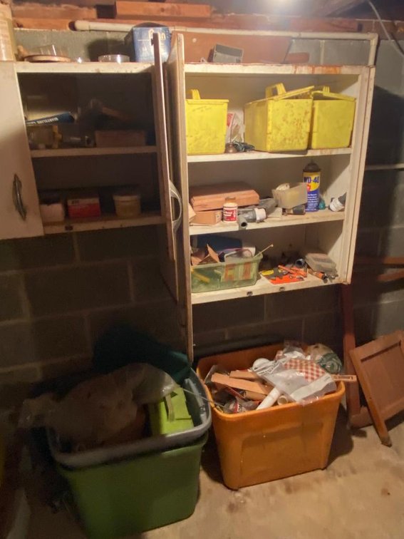 Contents of metal cabinets on wall and 2 plastic bins:  Hardware, tools, etc.