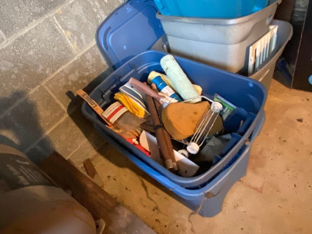 Plastic bins; one is full of paint supplies