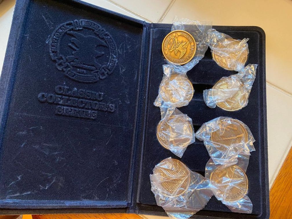 NRA Classic Collector Series coins in book