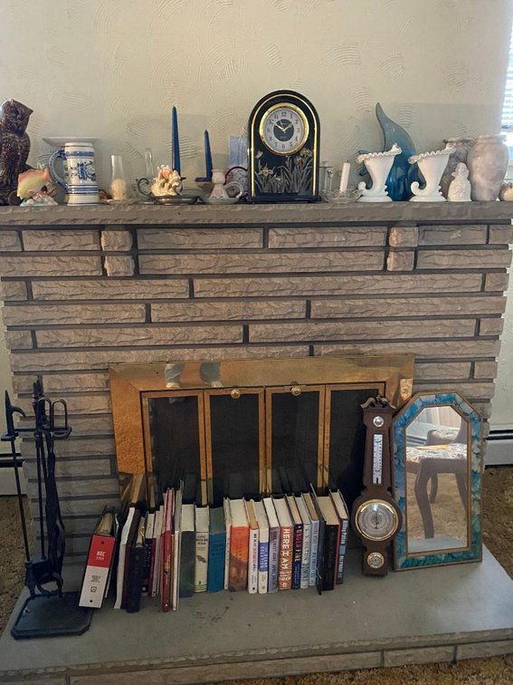 Contents of the fireplace shelf:  Decorator items, some milkglass, books, mirror, barometer, clock, etc.