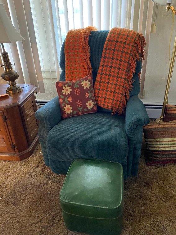 Upholstered lounge chair, vinyl foot stool, 2 throw shawls and a pillow