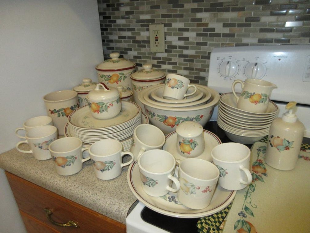 Assorted Corelle, Corning Ware and other table settings, cups, canisters, mixing bowls