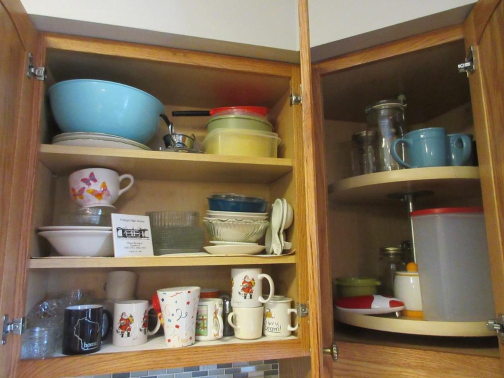 Contents of corner cabinets:  Mugs, bowls, canisters