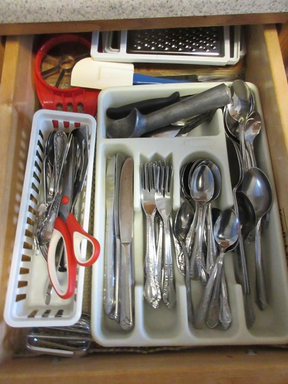 Contents of drawers:  Flatware, kitchen utensils, cookbooks