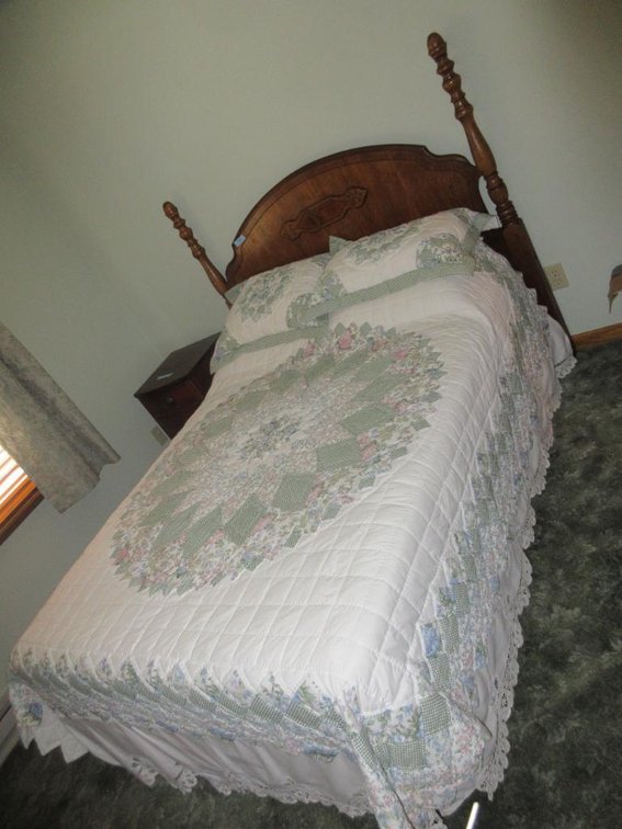 Full size bed w/ bedding and nightstand
