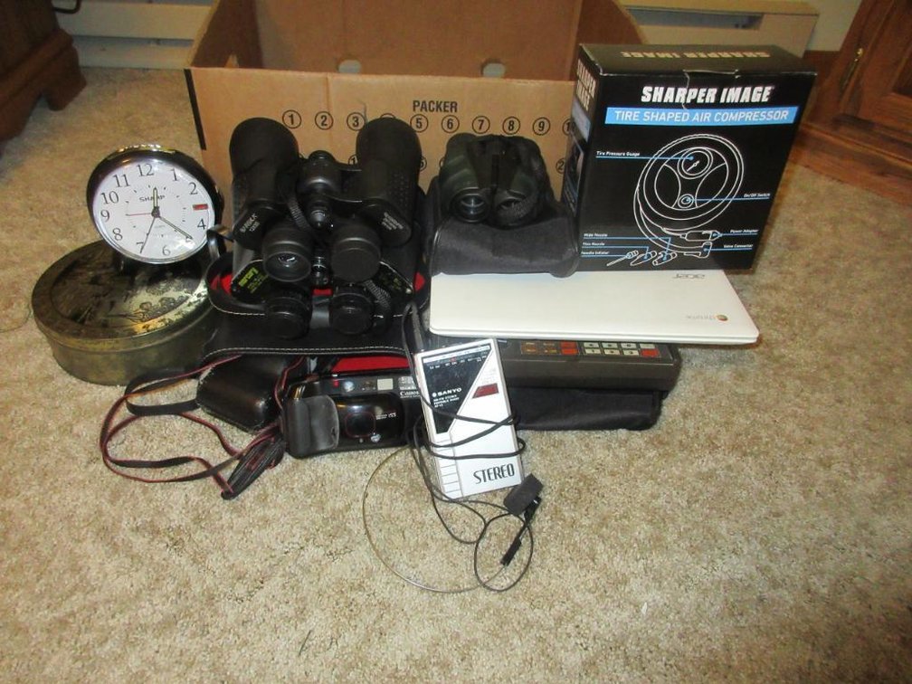 Binoculars, camera, alarm clock, Sanyo radio, etc.