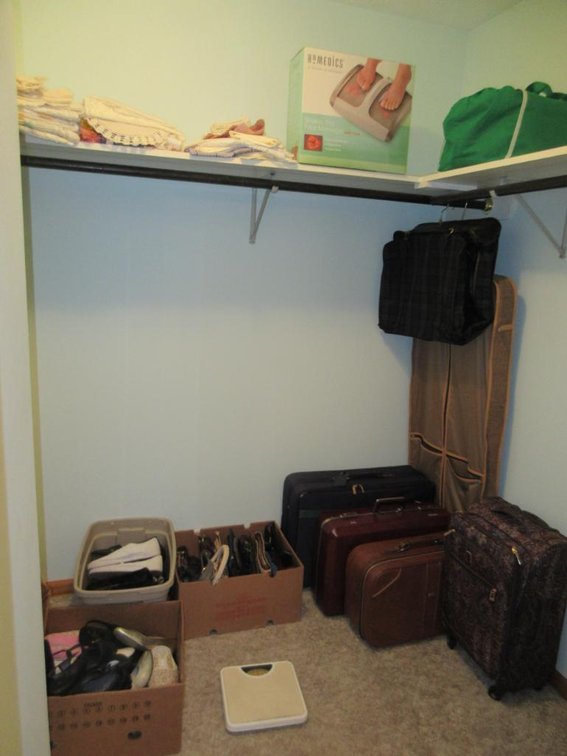 Contents of closet:  Luggage, foot massager, ladies' shoes, handbags, etc.