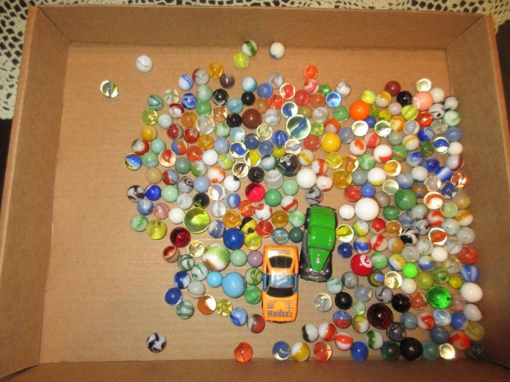 Assorted marbles and toy cars