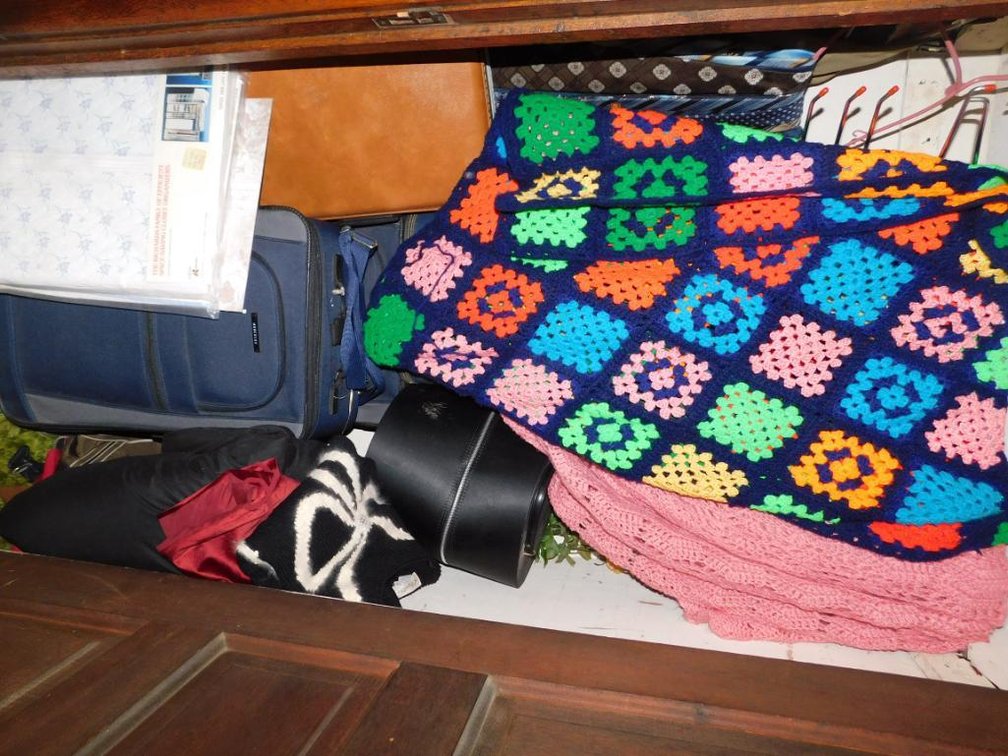 Contents of the closet:  Afghans, suitcases and electric blankets