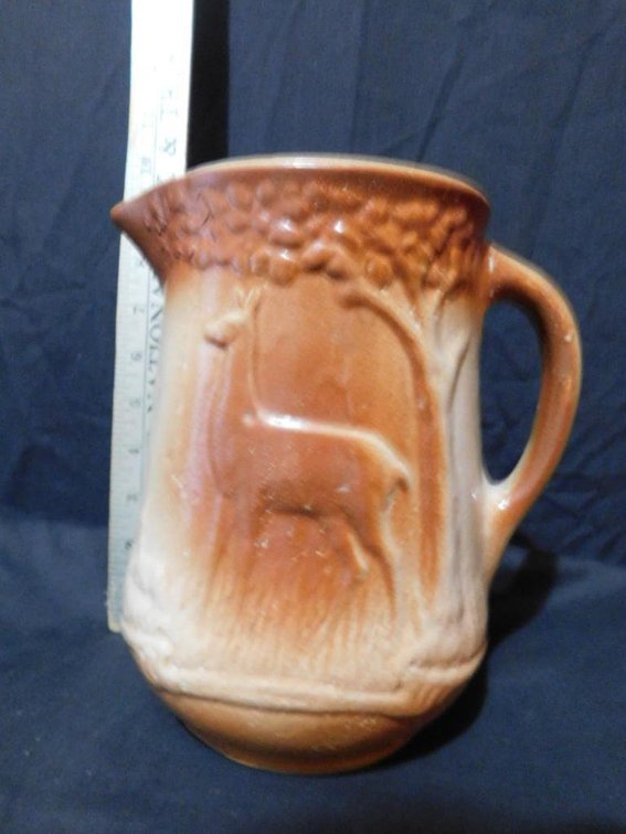 Cream and brown milk pitcher w/ deer