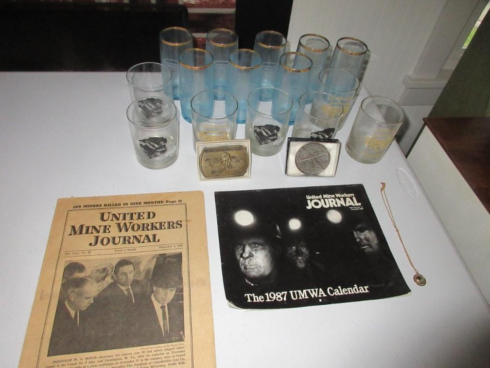Console glasses, belt buckles, necklace and United Mineworkers Journal calendar