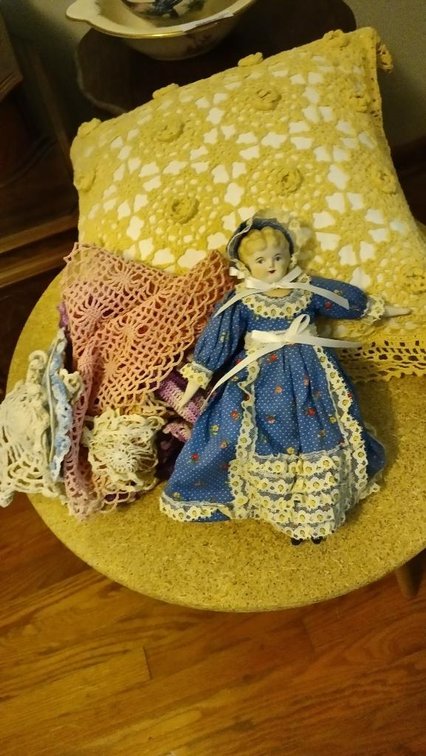 Pillow, doll and doilies