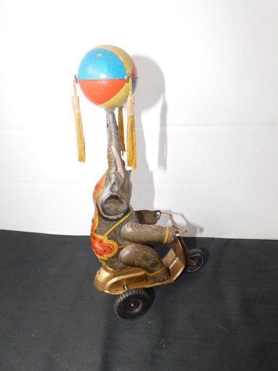 Collectible tin toy elephant on bike