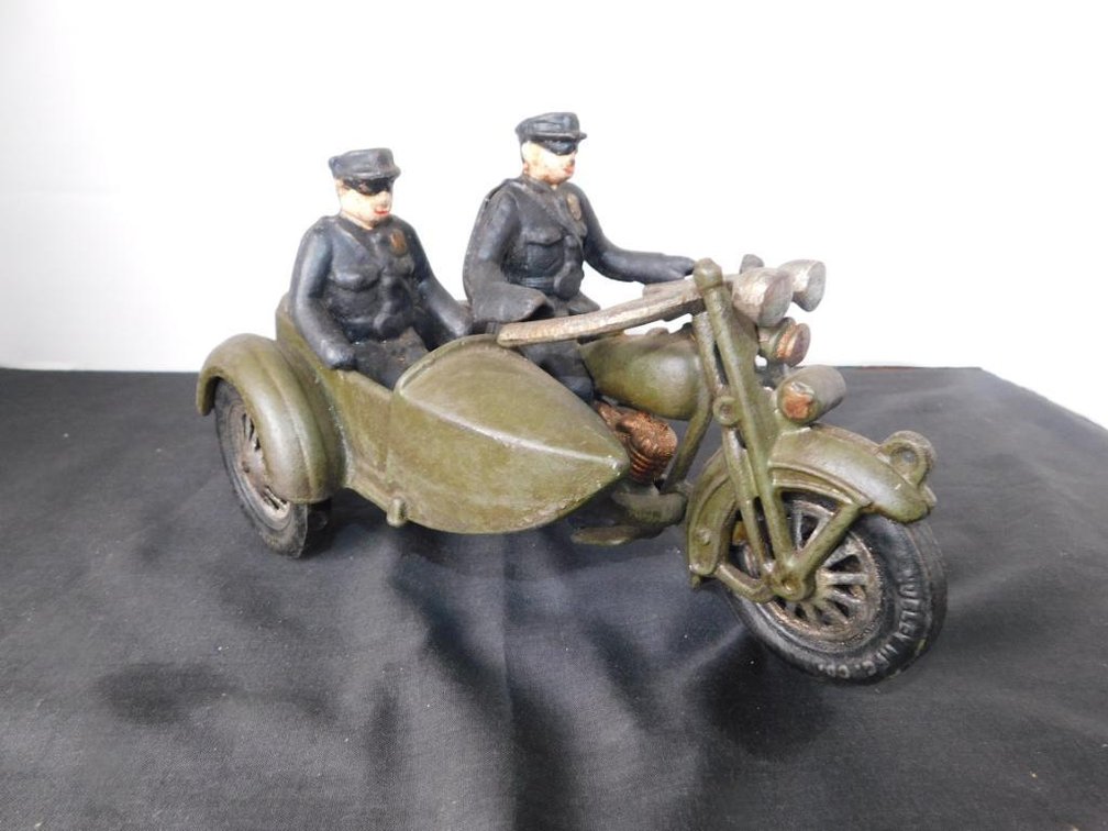 Cast metal man on motorcycle side cart