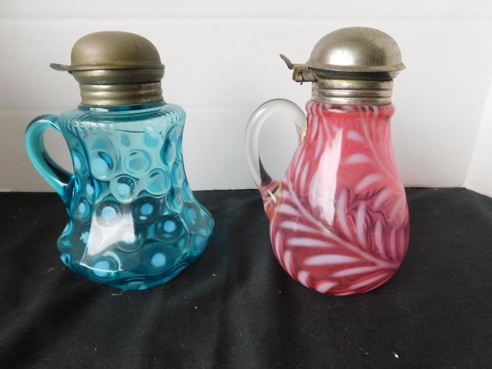 Cranberry swirl opalescent syrup pitcher and green moonstone syrup pitcher w/ damage