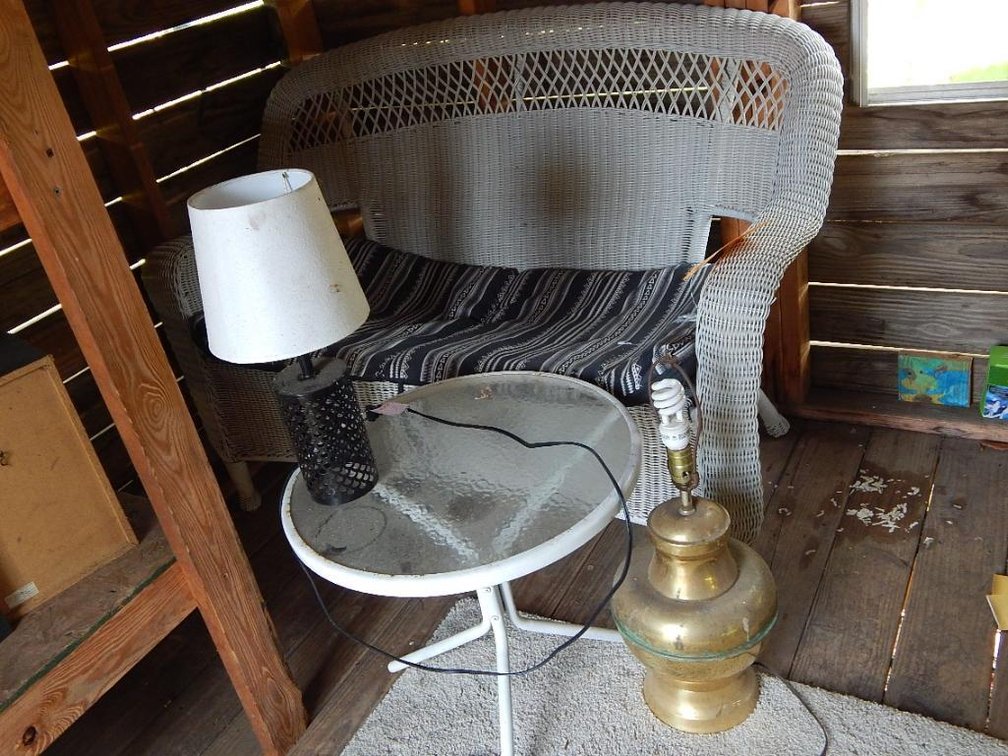 Wicker loveseat and metal end table w/ glass inserts and 2 lamps