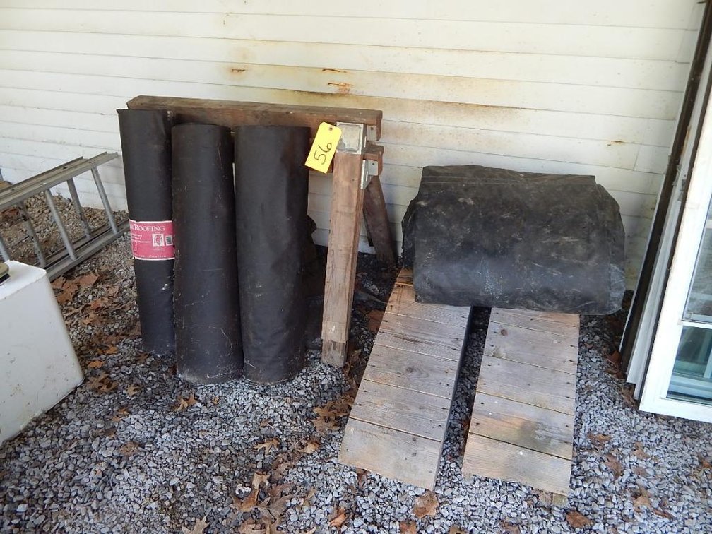2 Wooden car ramps, rubber tarp, 3 partial rolls of rolled roofing and 2 wooden sawhorses