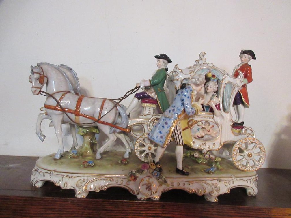Antique porcelain horse-drawn carriage and characters