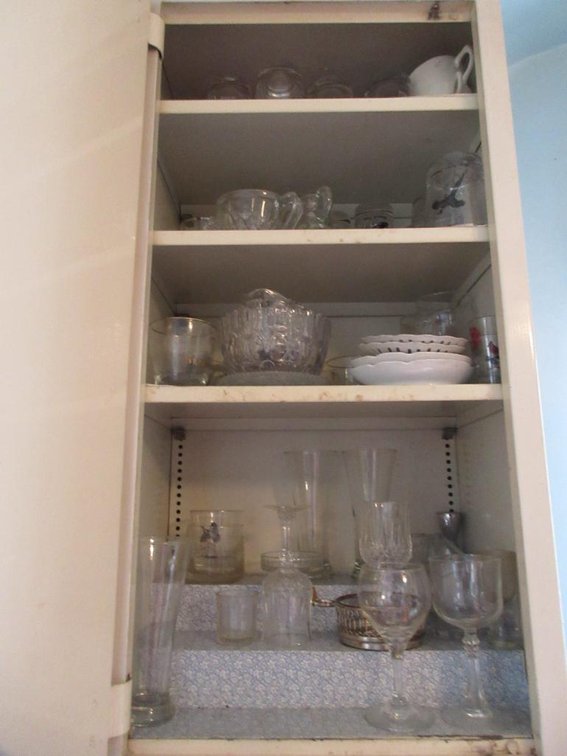 Contents of 3 drawers and 4 cabinets in the kitchen:  Cups, mixing cups, canning jars, flatware, kitchen utensils